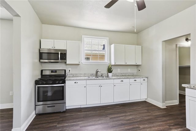 1816 Congress St, New Orleans, LA 70117 - kitchen with appliances with stainless steel finishes, a sink, a ceiling fan, and baseboards