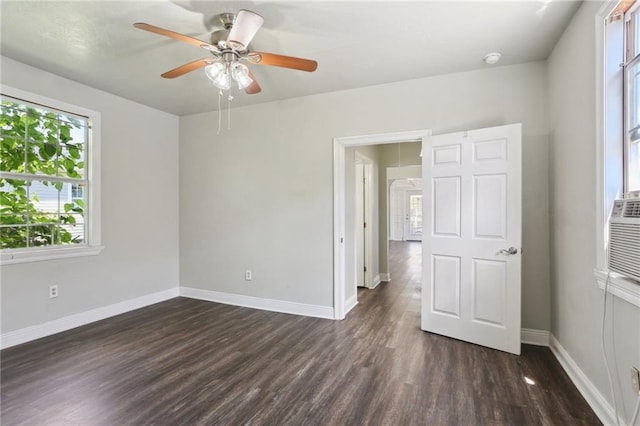1816 Congress St, New Orleans, LA 70117 - unfurnished bedroom with multiple windows, dark wood-style flooring, and baseboards