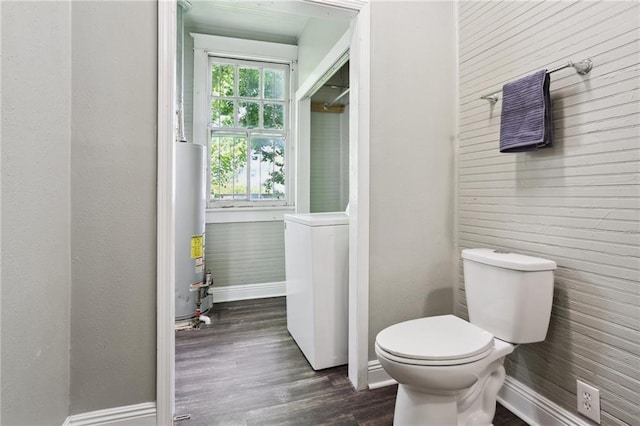 1816 Congress St, New Orleans, LA 70117 - bathroom featuring water heater, washer / clothes dryer, wood finished floors, toilet, and baseboards