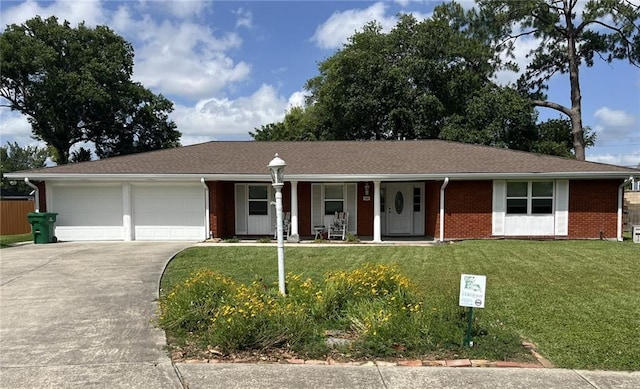 242 Willow Dr, Gretna, LA 70053 - ranch-style house with concrete driveway, a garage, a front lawn, a porch, and brick siding