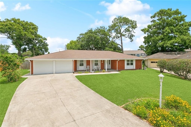 242 Willow Dr, Gretna, LA 70053 - ranch-style home with a porch, driveway, a front yard, a garage, and brick siding