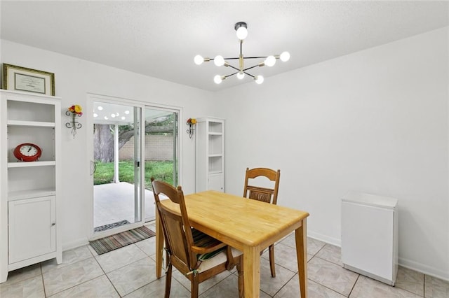 242 Willow Dr, Gretna, LA 70053 - dining space featuring a chandelier, light tile patterned floors, and baseboards