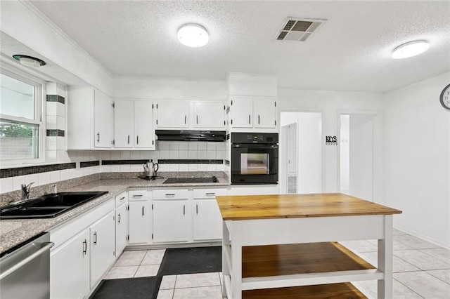 242 Willow Dr, Gretna, LA 70053 - kitchen with black appliances, a sink, a textured ceiling, light tile patterned floors, and under cabinet range hood