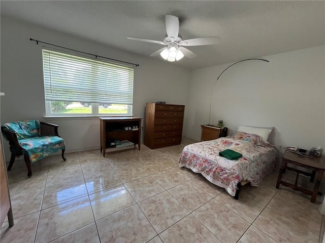 242 Willow Dr, Gretna, LA 70053 - bedroom with a ceiling fan, a textured ceiling, and light tile patterned floors