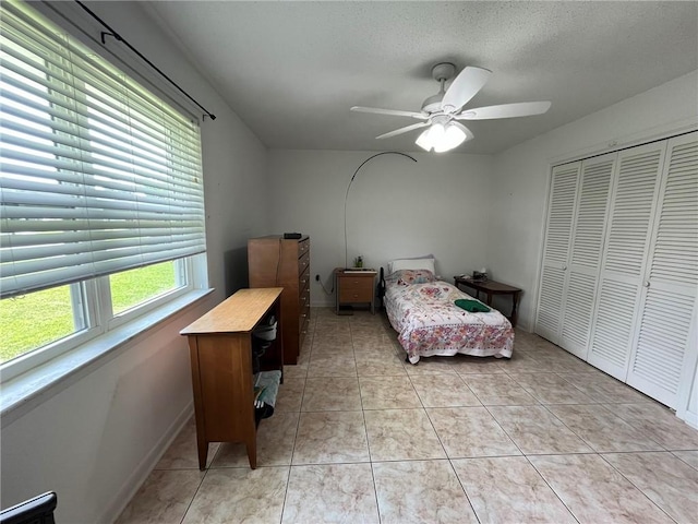 242 Willow Dr, Gretna, LA 70053 - bedroom featuring a closet, light tile patterned floors, ceiling fan, and baseboards