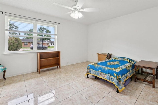 242 Willow Dr, Gretna, LA 70053 - bedroom featuring light tile patterned floors, a ceiling fan, and baseboards