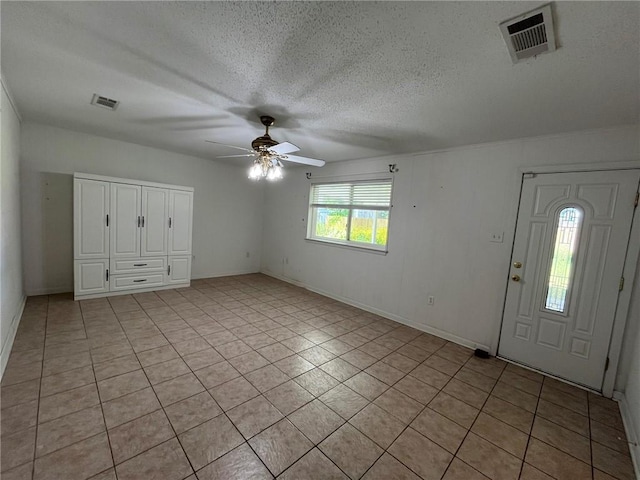 242 Willow Dr, Gretna, LA 70053 - entrance foyer featuring a ceiling fan, light tile patterned floors, a textured ceiling, and baseboards