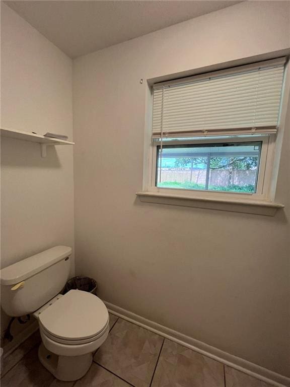 242 Willow Dr, Gretna, LA 70053 - bathroom featuring toilet, baseboards, and tile patterned floors
