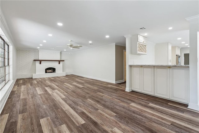 4233 Bordeaux Dr, Kenner, LA 70065 - unfurnished living room featuring ceiling fan, dark wood finished floors, a fireplace, ornamental molding, and recessed lighting