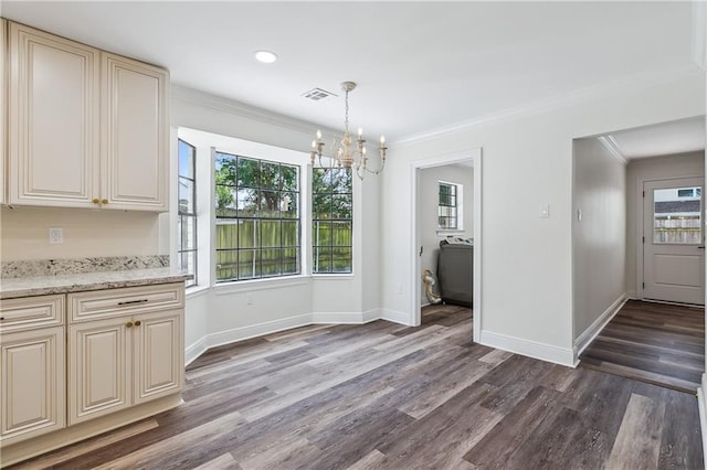 4233 Bordeaux Dr, Kenner, LA 70065 - unfurnished dining area featuring a chandelier, crown molding, dark wood-style flooring, baseboards, and healthy amount of natural light