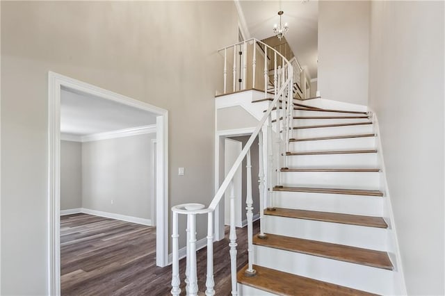 4233 Bordeaux Dr, Kenner, LA 70065 - staircase featuring crown molding, wood finished floors, baseboards, and a towering ceiling