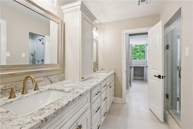 4233 Bordeaux Dr, Kenner, LA 70065 - full bath with a stall shower, double vanity, tile patterned floors, and baseboards