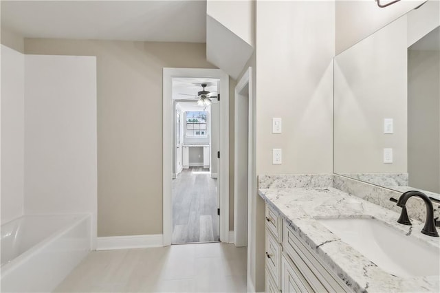 4233 Bordeaux Dr, Kenner, LA 70065 - full bath with ceiling fan, baseboards, vanity, and a bath