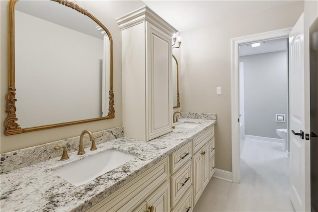 4233 Bordeaux Dr, Kenner, LA 70065 - bathroom with double vanity, toilet, and baseboards