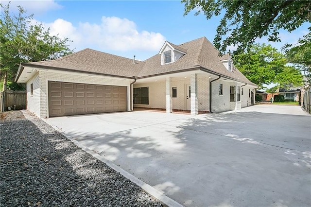 4233 Bordeaux Dr, Kenner, LA 70065 - view of front facade featuring concrete driveway, brick siding, an attached garage, and fence