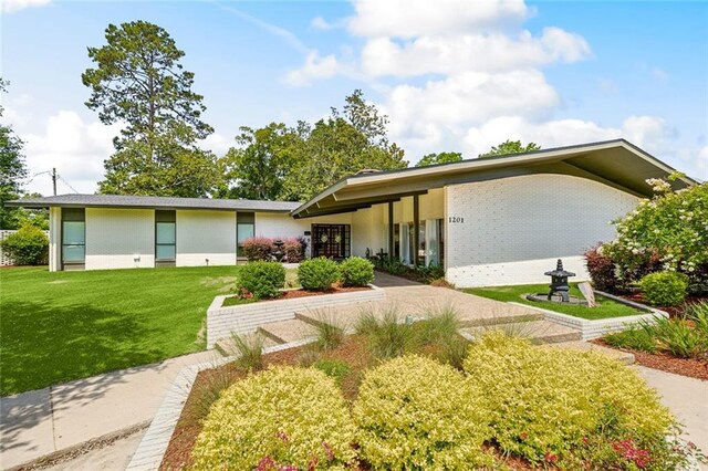 1201 N General Pershing St, Hammond, LA 70401 - mid-century home with a front yard and brick siding