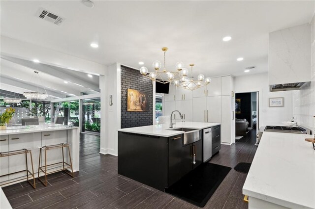 1201 N General Pershing St, Hammond, LA 70401 - kitchen with a sink, a chandelier, a center island with sink, dark wood-type flooring, and recessed lighting