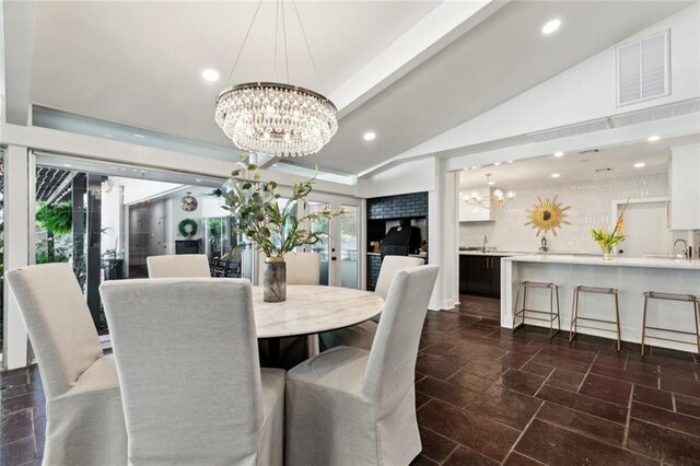 1201 N General Pershing St, Hammond, LA 70401 - dining space featuring a chandelier, vaulted ceiling, recessed lighting, and stone tile floors