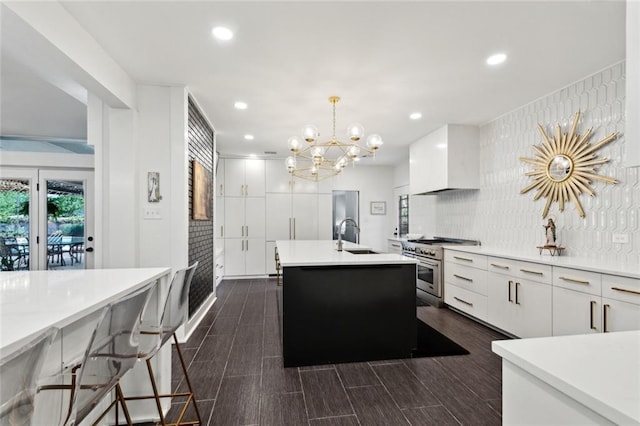 1201 N General Pershing St, Hammond, LA 70401 - kitchen with stainless steel range, white cabinetry, a center island with sink, light countertops, and recessed lighting
