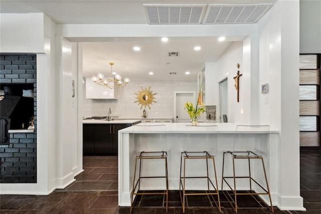 1201 N General Pershing St, Hammond, LA 70401 - kitchen with light countertops, a kitchen bar, recessed lighting, a peninsula, and a fireplace