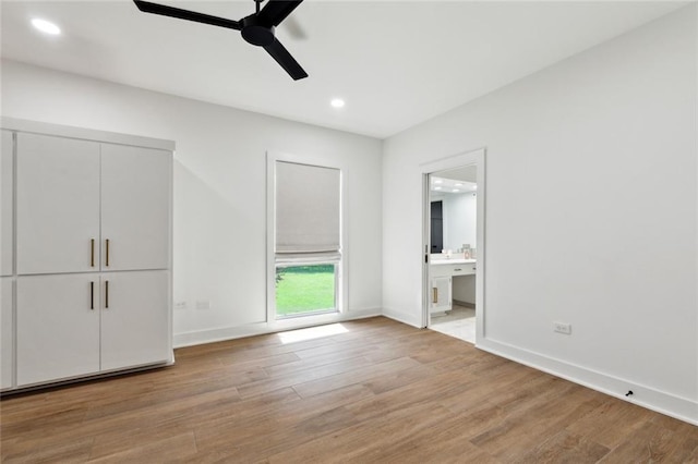 1201 N General Pershing St, Hammond, LA 70401 - unfurnished bedroom with light wood-style flooring, recessed lighting, baseboards, and connected bathroom