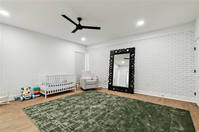 1201 N General Pershing St, Hammond, LA 70401 - bedroom featuring wood finished floors, brick wall, recessed lighting, and a ceiling fan