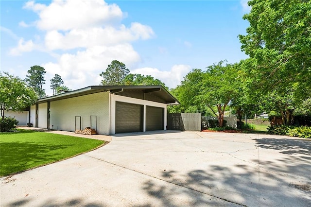 1201 N General Pershing St, Hammond, LA 70401 - view of home's exterior featuring brick siding, concrete driveway, and an attached garage