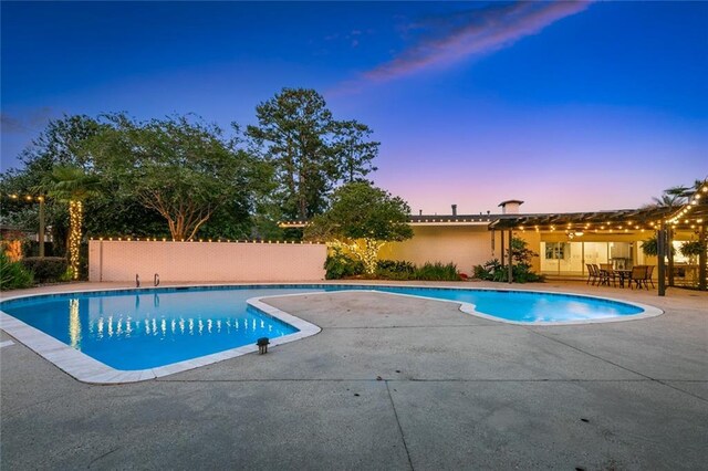 1201 N General Pershing St, Hammond, LA 70401 - pool at dusk with a patio and fence