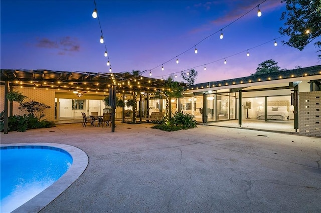 1201 N General Pershing St, Hammond, LA 70401 - rear view of house featuring brick siding, a patio area, and an outdoor pool