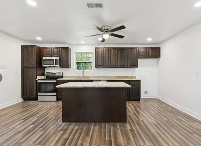 333 Killona Dr, Killona, LA 70057 - kitchen with appliances with stainless steel finishes, recessed lighting, baseboards, and dark wood finished floors