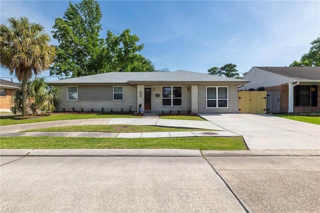 6304 Asher St, Metairie, LA 70003 - single story home featuring concrete driveway, a front lawn, and a gate