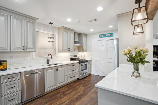5835 Chamberlain Dr, New Orleans, LA 70122 - kitchen with appliances with stainless steel finishes, a sink, wall chimney range hood, dark wood-style flooring, and gray cabinetry