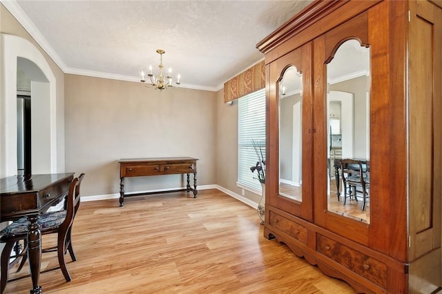 3851 Croydon St, Slidell, LA 70458 - dining room featuring arched walkways, light wood finished floors, a chandelier, ornamental molding, and baseboards