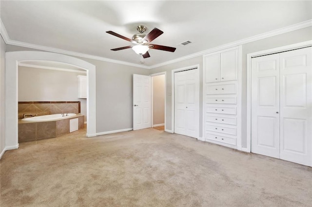 409 Markham Dr, Slidell, LA 70458 - unfurnished bedroom with multiple closets, ornamental molding, light carpet, baseboards, and ensuite bathroom