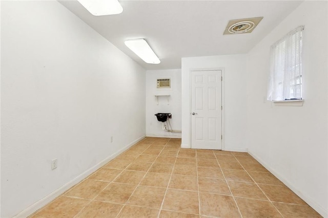 409 Markham Dr, Slidell, LA 70458 - unfurnished room featuring light tile patterned floors, a wall mounted air conditioner, and baseboards