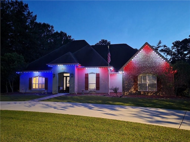 69359 6th Ave, Covington, LA 70433 - view of front facade with a front lawn, brick siding, and stucco siding