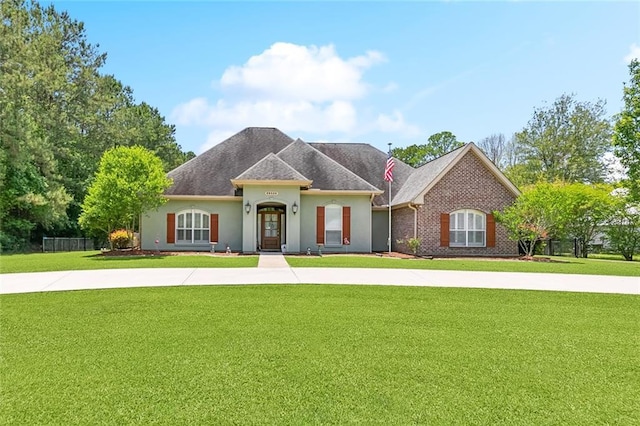 69359 6th Ave, Covington, LA 70433 - french provincial home featuring a front yard and stucco siding