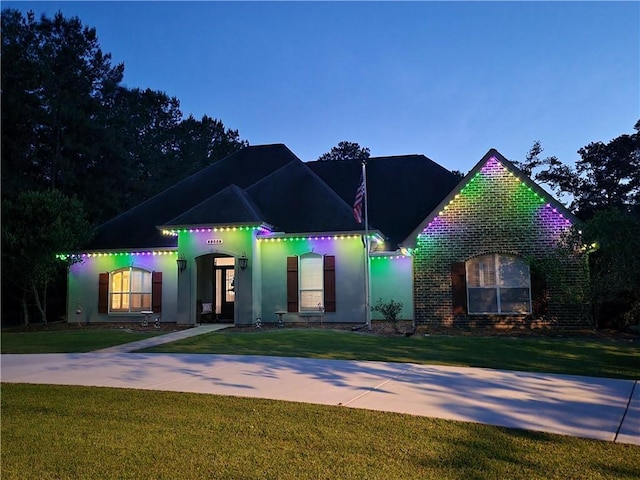 69359 6th Ave, Covington, LA 70433 - view of front of house with a front yard, brick siding, and stucco siding