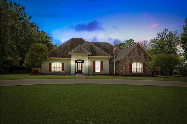 69359 6th Ave, Covington, LA 70433 - french provincial home featuring a front yard and stucco siding