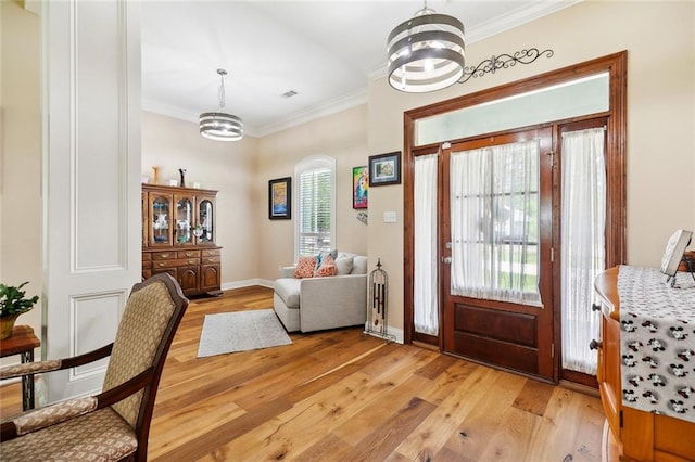 69359 6th Ave, Covington, LA 70433 - entryway with light wood-style floors, a chandelier, crown molding, baseboards, and arched walkways