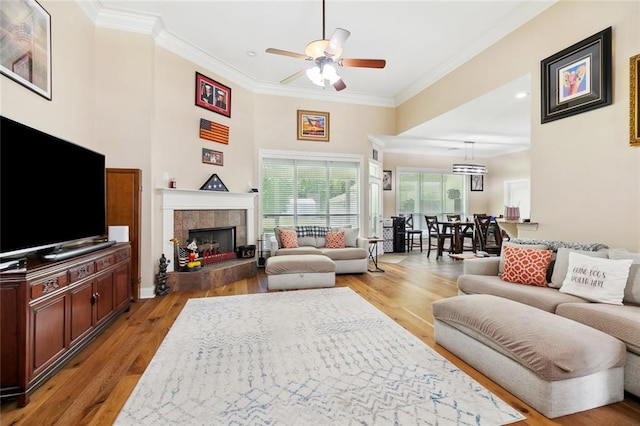 69359 6th Ave, Covington, LA 70433 - living area with ceiling fan, crown molding, light wood finished floors, a tile fireplace, and baseboards
