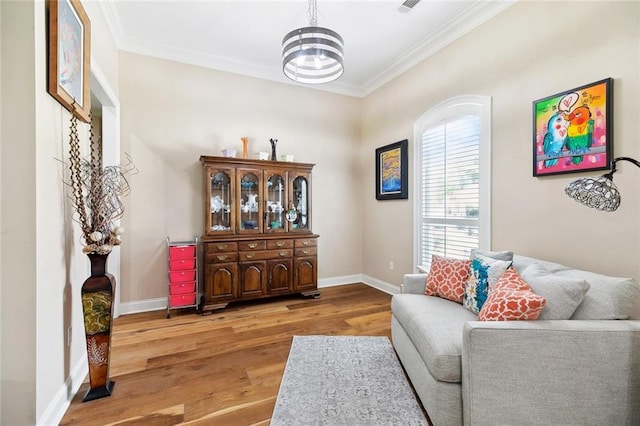 69359 6th Ave, Covington, LA 70433 - sitting room with wood finished floors, ornamental molding, and baseboards
