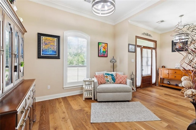69359 6th Ave, Covington, LA 70433 - entrance foyer featuring light wood-type flooring, baseboards, ornamental molding, and a chandelier