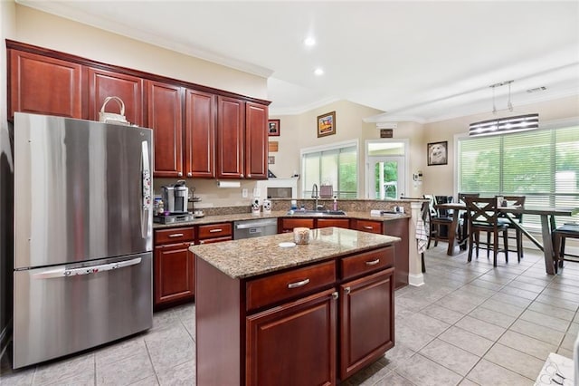 69359 6th Ave, Covington, LA 70433 - kitchen featuring stainless steel appliances, a sink, ornamental molding, light tile patterned flooring, and a peninsula