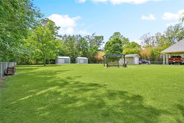 69359 6th Ave, Covington, LA 70433 - view of yard with a storage unit, an outdoor structure, a pergola, and view of wooded area