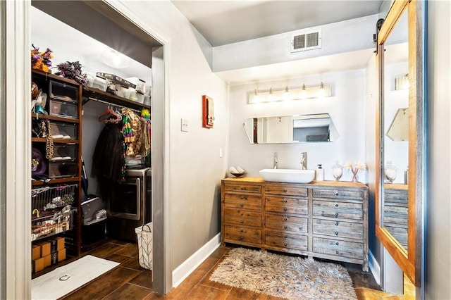 3000 Saint Charles Ave Unit 408, New Orleans, LA 70115 - full bathroom featuring vanity, baseboards, and a walk in closet