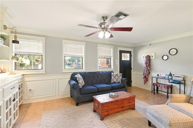6200 Morton St, Metairie, LA 70003 - living room with light tile patterned floors, plenty of natural light, crown molding, a decorative wall, and a ceiling fan