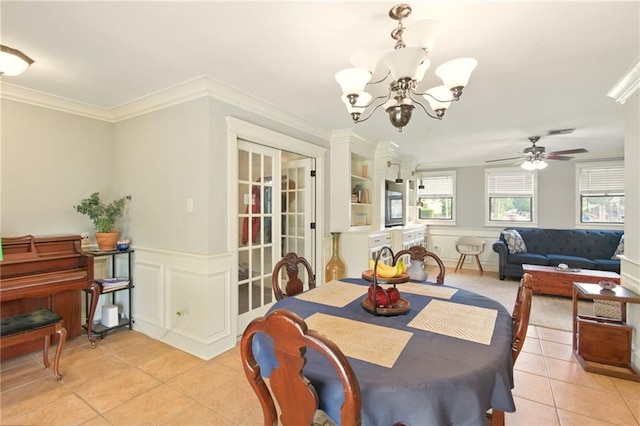 6200 Morton St, Metairie, LA 70003 - dining room featuring light tile patterned floors, a chandelier, a ceiling fan, ornamental molding, and a wainscoted wall