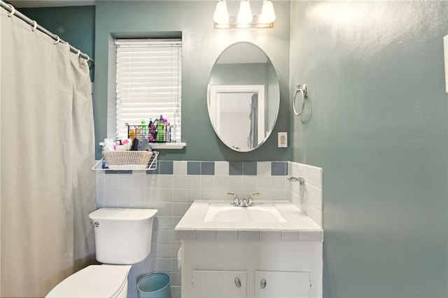 6200 Morton St, Metairie, LA 70003 - bathroom featuring tile walls, toilet, and vanity