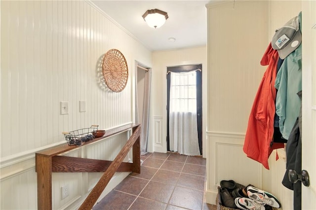 6200 Morton St, Metairie, LA 70003 - entryway with a decorative wall, dark tile patterned flooring, and crown molding